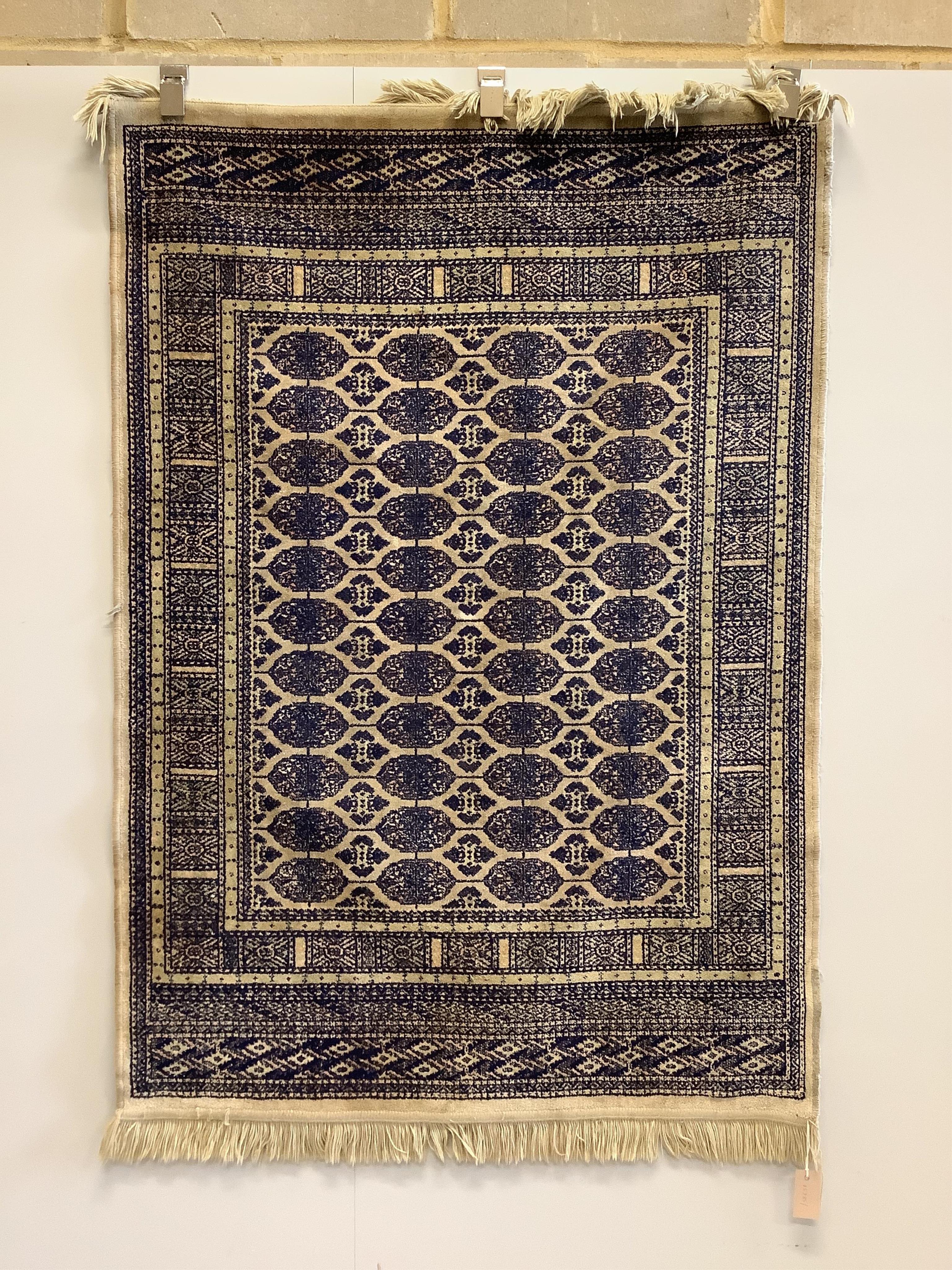 A silk blue and cream rug, 141 x 100cm. Condition - poor to fair